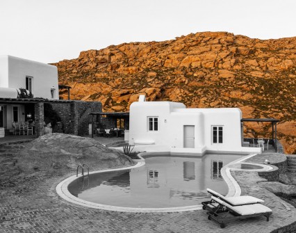 Have a drink by your houses pool with a background of rocks that assume a Mars-like colour during the beginning of sunset